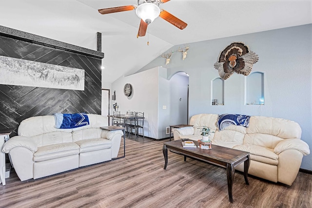 living room with ceiling fan, hardwood / wood-style flooring, and vaulted ceiling