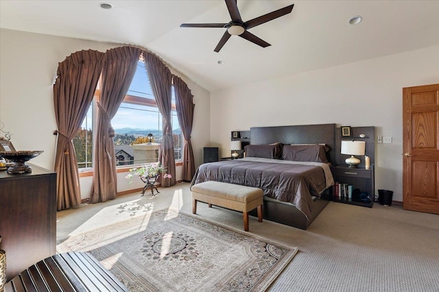 carpeted bedroom with vaulted ceiling and ceiling fan