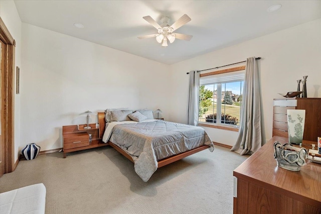 bedroom with light colored carpet and ceiling fan