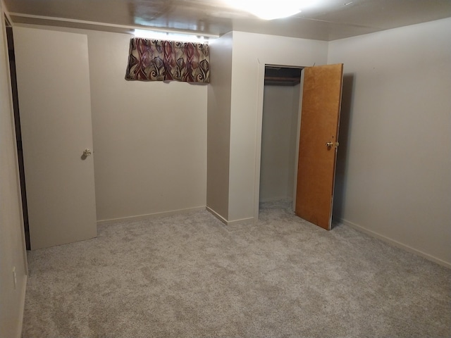 interior space with light carpet and a closet