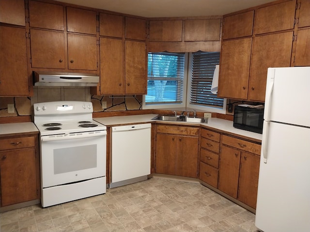 kitchen featuring sink and white appliances