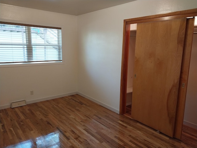 unfurnished bedroom featuring a closet and wood-type flooring