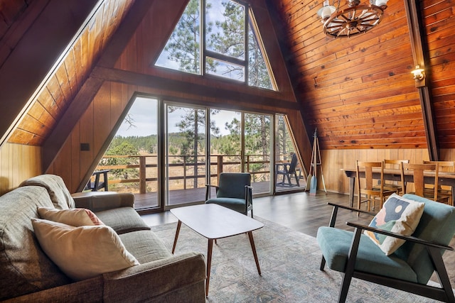 living room with wood walls, high vaulted ceiling, wood-type flooring, and a wealth of natural light