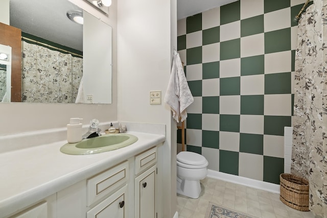 bathroom with vanity, toilet, and a textured ceiling