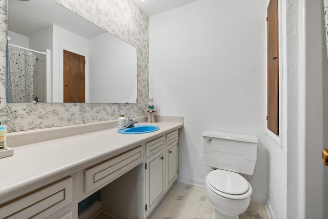 bathroom featuring toilet and vanity