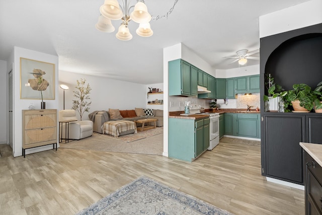 kitchen with light hardwood / wood-style floors, backsplash, sink, white electric range oven, and ceiling fan with notable chandelier