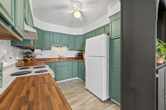 kitchen with butcher block counters, light hardwood / wood-style floors, sink, white appliances, and ceiling fan