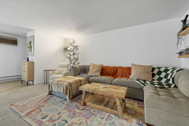 living room with baseboard heating, a textured ceiling, and light wood-type flooring