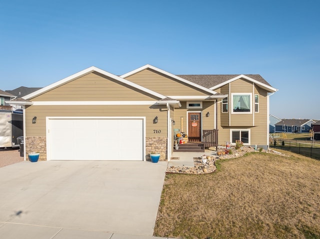 view of front of house with a front yard and a garage