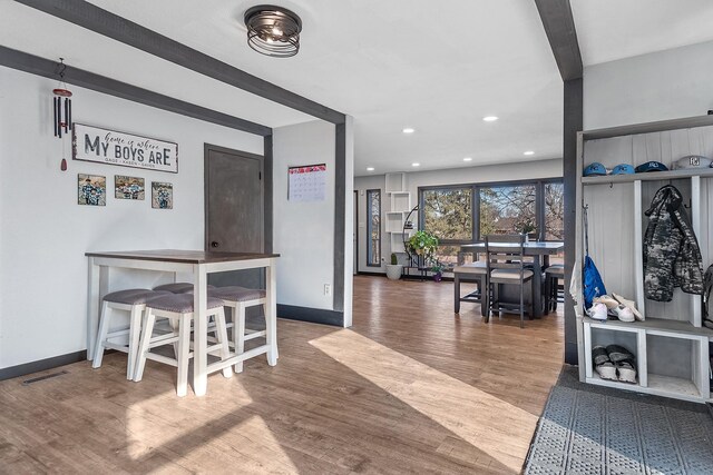 interior space featuring hardwood / wood-style floors and beam ceiling