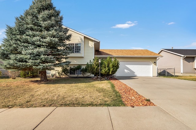 view of front of property featuring a garage and a front lawn