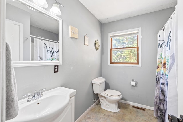 bathroom featuring vanity, a shower with curtain, and toilet