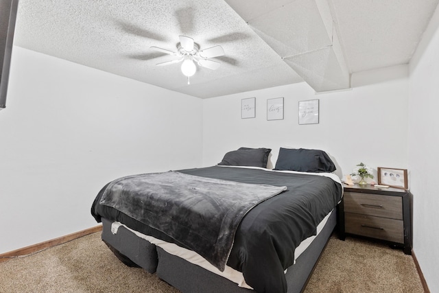 carpeted bedroom featuring a textured ceiling and ceiling fan