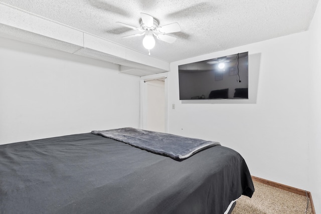 carpeted bedroom featuring a textured ceiling and ceiling fan