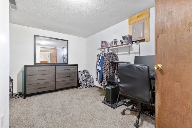 home office with light carpet and a textured ceiling