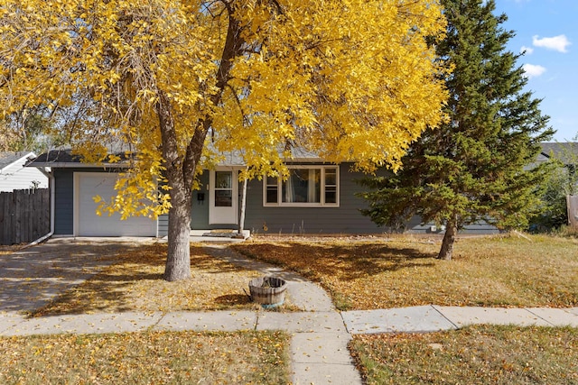 view of property hidden behind natural elements featuring a garage