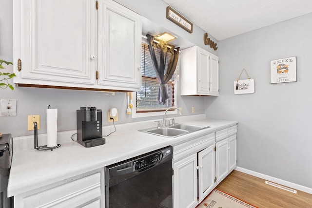 kitchen with black dishwasher, white cabinetry, a textured ceiling, light hardwood / wood-style floors, and sink