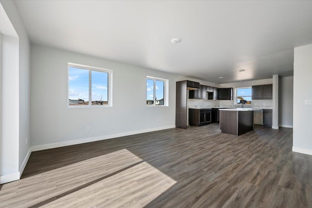 10899 Eagle Ct, Belle Fourche, SD 57717 - kitchen with a center island, open floor plan, dark wood-type flooring, and baseboards