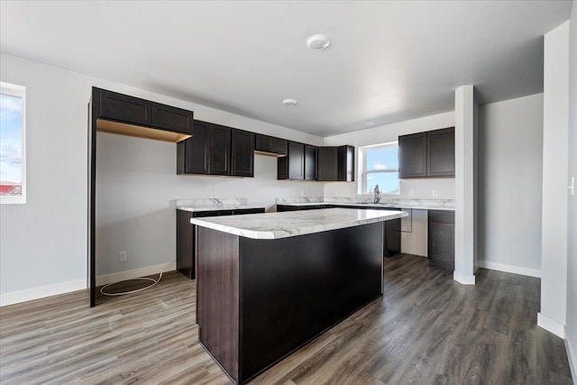 10899 Eagle Ct, Belle Fourche, SD 57717 - kitchen with a center island, a sink, baseboards, and wood finished floors