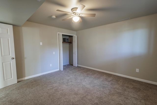 unfurnished bedroom featuring a closet, ceiling fan, and carpet flooring