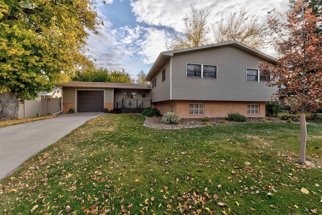 split level home with a front lawn and a garage