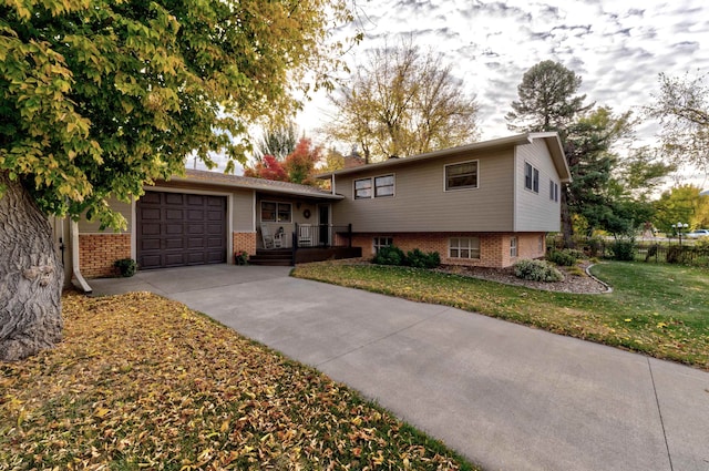 split level home with a front yard and a garage