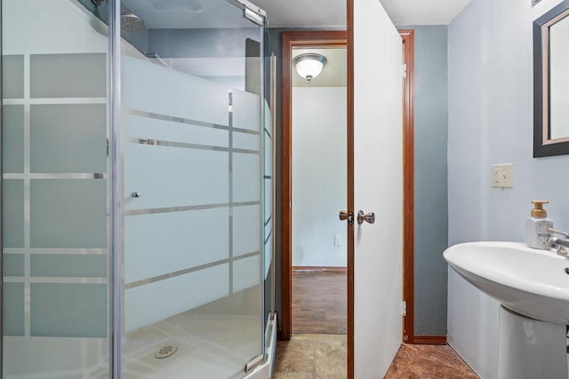 bathroom featuring a shower with shower door