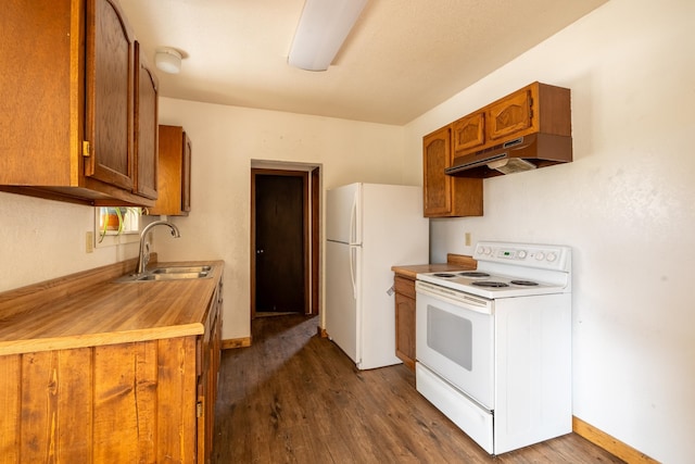 kitchen with white appliances, range hood, sink, and dark hardwood / wood-style floors