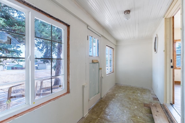 doorway to outside with wood ceiling