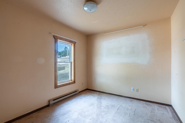 spare room featuring light carpet, a textured ceiling, and a baseboard radiator