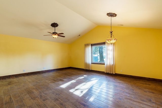 empty room with ceiling fan, lofted ceiling, and dark hardwood / wood-style floors