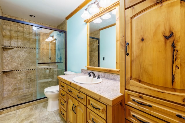 bathroom with toilet, an enclosed shower, and vanity