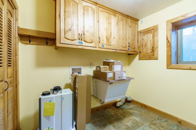 washroom with washer hookup and cabinets