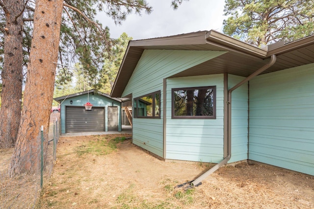 view of side of home with a garage and an outdoor structure