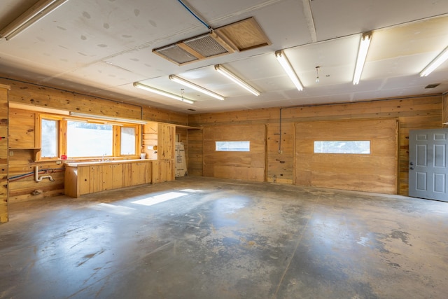 interior space with wood walls and concrete flooring