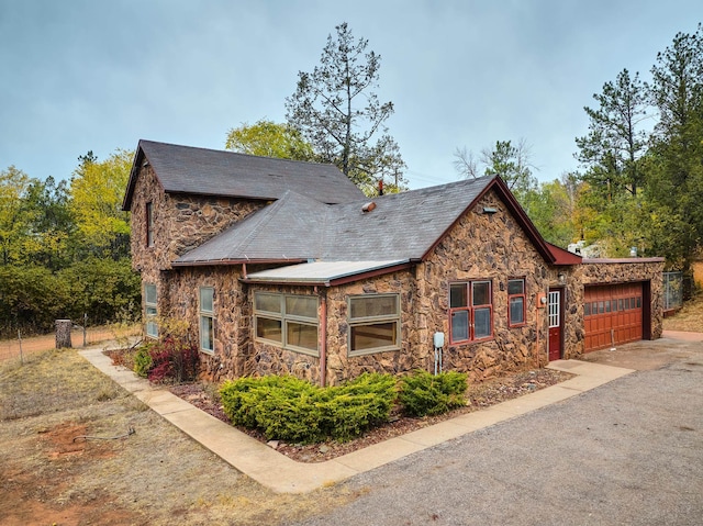 view of side of home featuring a garage