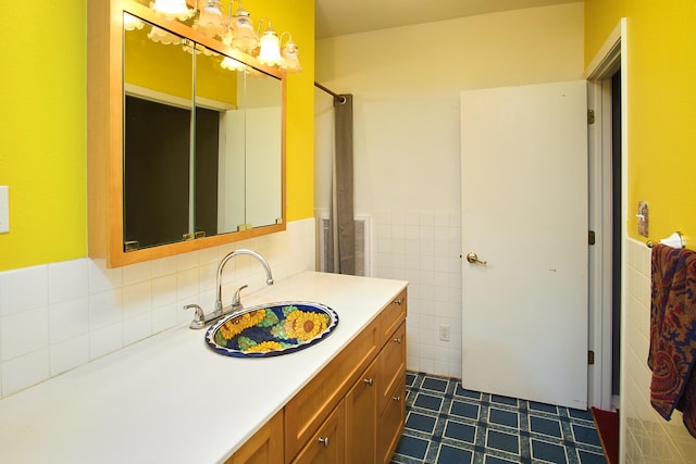 bathroom with vanity and tile walls