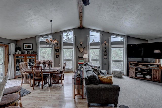 dining space with a notable chandelier, vaulted ceiling with beams, and light hardwood / wood-style floors