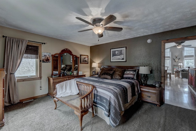 bedroom featuring multiple windows, a textured ceiling, and ceiling fan