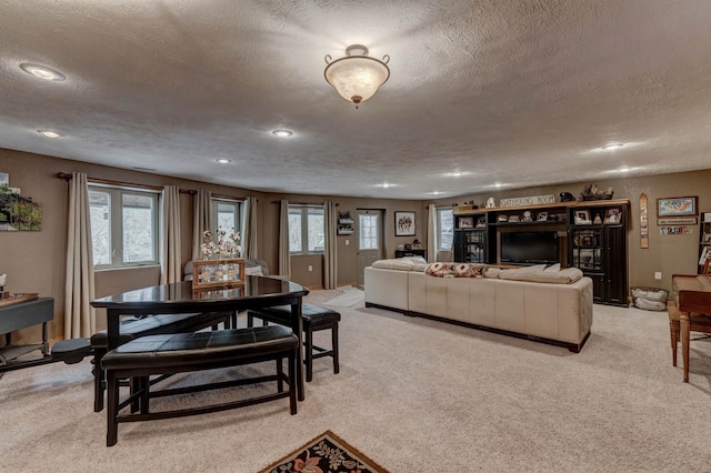 dining room featuring light carpet and a textured ceiling