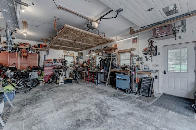 garage featuring a garage door opener and a workshop area