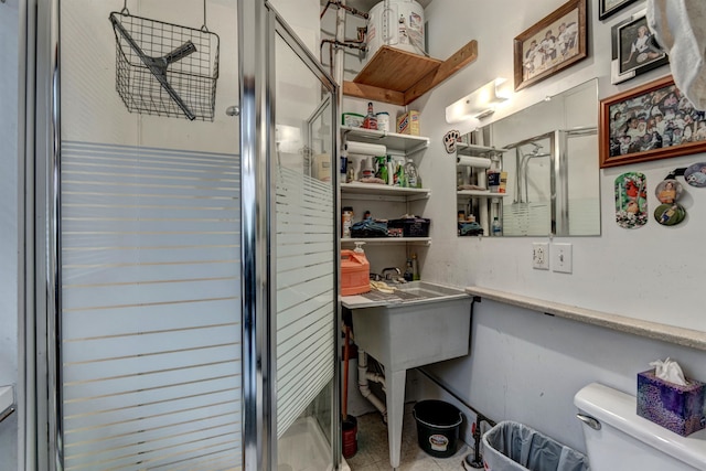 bathroom with toilet, an enclosed shower, and tile patterned flooring