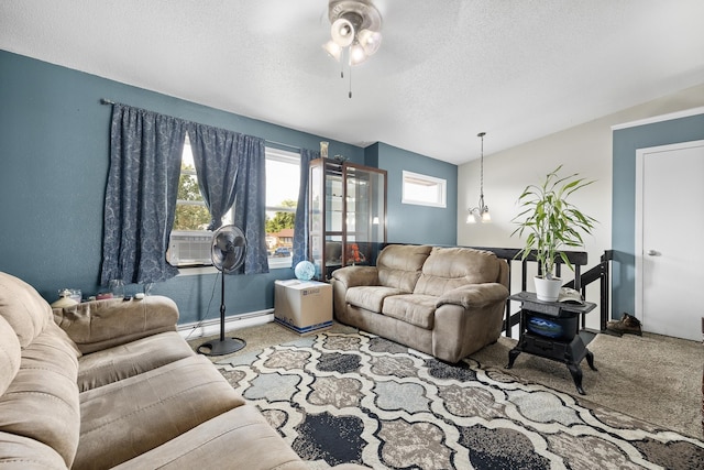 carpeted living room featuring ceiling fan, a textured ceiling, and cooling unit