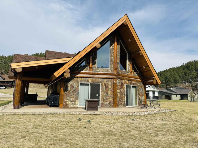 115 Minor Lake Cir, Hill City, SD 57745 - living room with high vaulted ceiling, wooden ceiling, beamed ceiling, and a wood stove