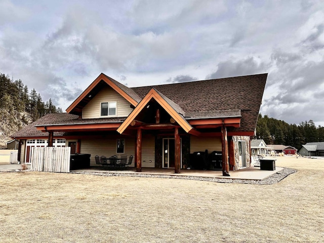 115 Minor Lake Cir, Hill City, SD 57745 - view of front of house with a garage, concrete driveway, a front lawn, and roof with shingles