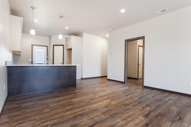 unfurnished living room with dark hardwood / wood-style flooring