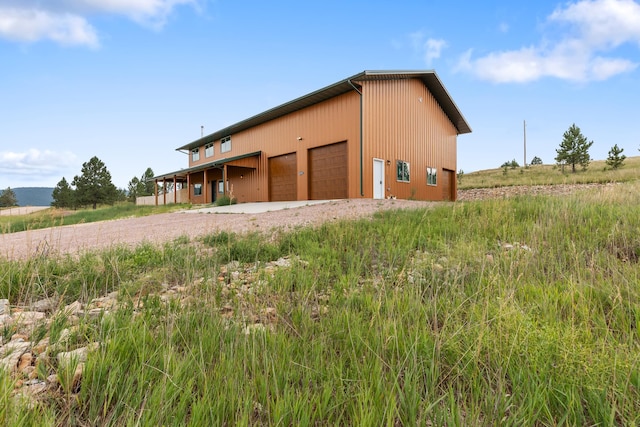 view of outbuilding with a rural view and a garage