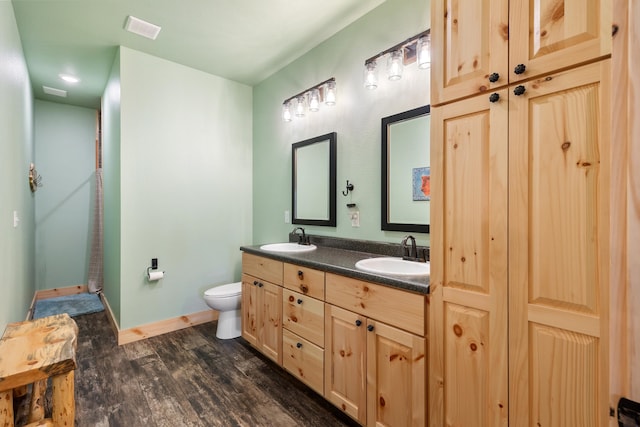 bathroom featuring vanity, hardwood / wood-style floors, toilet, and an enclosed shower