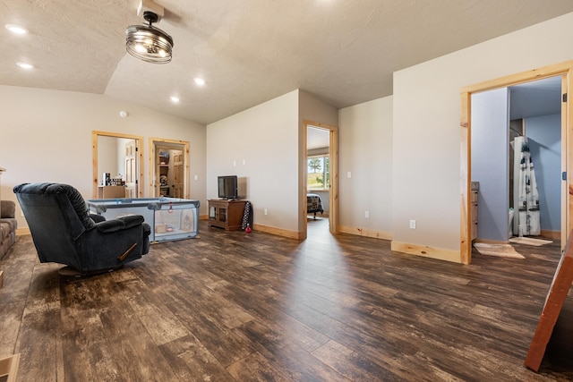 living room featuring lofted ceiling, a textured ceiling, and dark hardwood / wood-style flooring