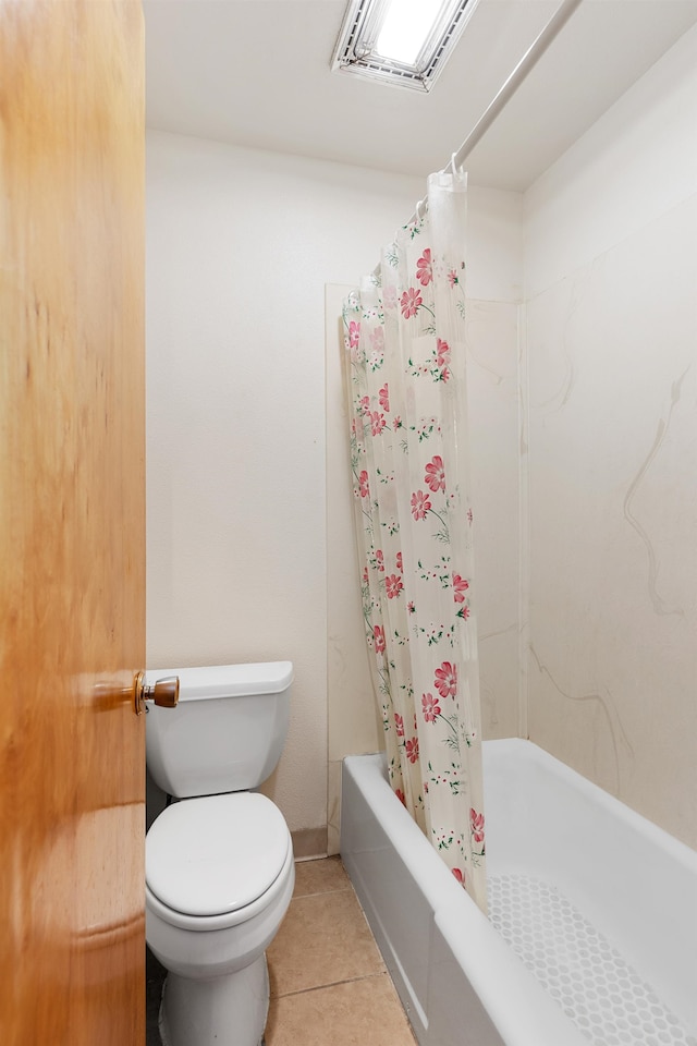 bathroom with shower / tub combo with curtain, tile patterned floors, and toilet